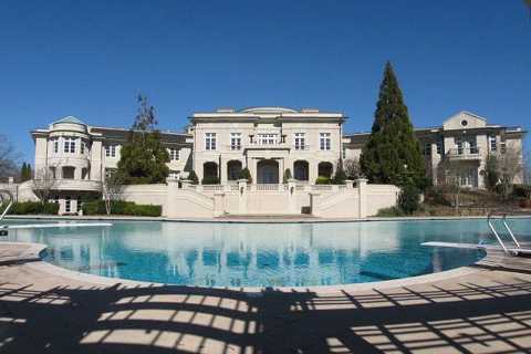 Evander Holyfield’s amazing 109-room Georgia home he sold to Rick Ross for $5.7m boasts bowling alley, theatre and pool