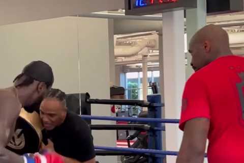 Watch Deontay Wilder’s coach take punch flush on chin from fearsome boxer but stay on his feet in training