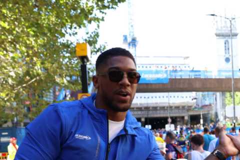 Anthony Joshua hands out drinks to stunned London Marathon runners who stop for selfies as Tyson Fury talks rumble on