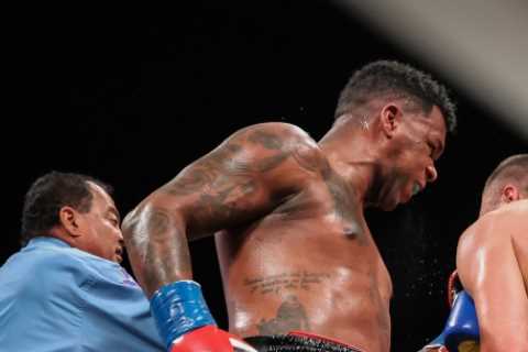 Watch as fearsome heavyweight is stunned by brutal shot to ribs before he takes savage beating to lose first fight