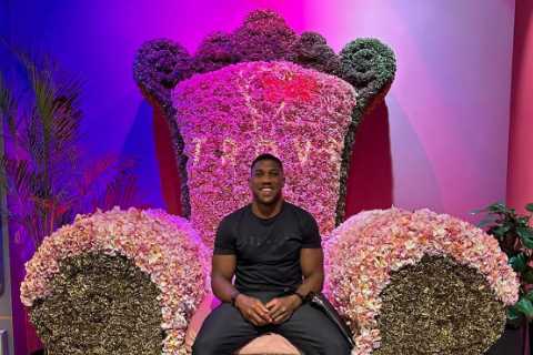 Anthony Joshua sits on huge throne at Dubai restaurant as he enjoys some time off after fight delay announcement