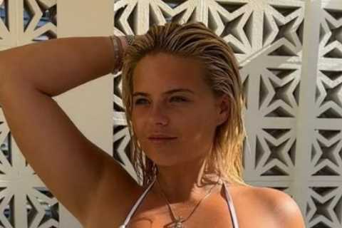 Busty Misfits ring girl Apollonia Llewellyn nearly bursts out of tiny hot pink bikini as she tops up tan on holiday