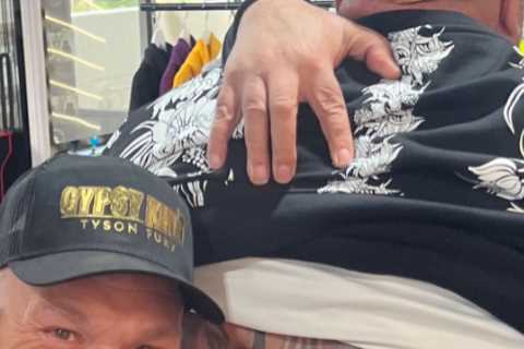 Tyson Fury beams as he meets die-hard fan who has huge tattoo of Gypsy King on his back