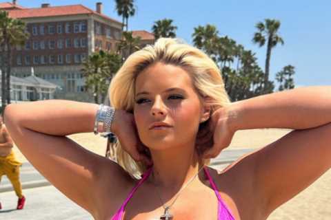 Busty boxing ring girl Apollonia Llewellyn shows off major underboob as she almost spills out of tiny bikini