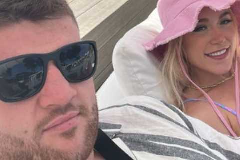 Elle Brooke relaxes in bikini in Magaluf then bursts into laughter as her huge boxer pal is ‘started on’